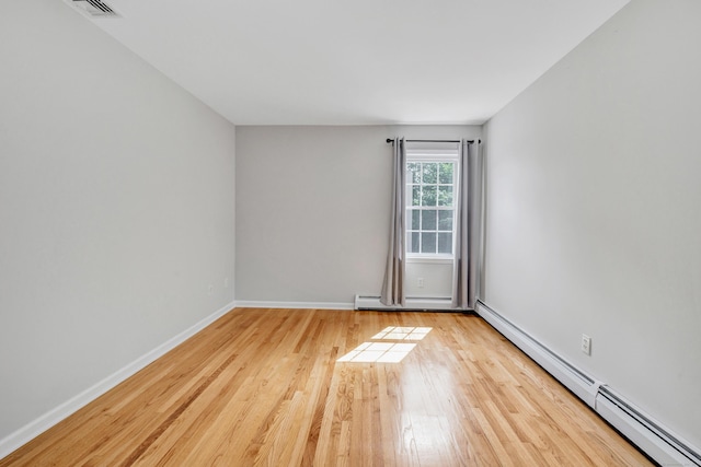 90 Chamberlain Dr, Shelton, CT 06484 - empty room with a baseboard heating unit, wood finished floors, and baseboard heating