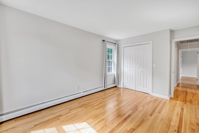 90 Chamberlain Dr, Shelton, CT 06484 - unfurnished bedroom with attic access, light wood-style floors, a baseboard heating unit, and a closet