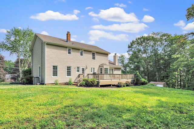 90 Chamberlain Dr, Shelton, CT 06484 - back of property with a chimney, a wooden deck, and a yard