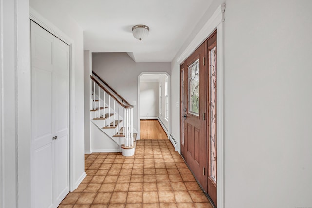 90 Chamberlain Dr, Shelton, CT 06484 - entryway with arched walkways, stairs, and a baseboard heating unit