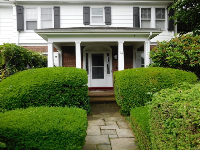 58 Edward St, East Haven, CT 06512 - doorway to property with a porch and brick siding