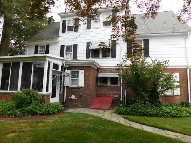 58 Edward St, East Haven, CT 06512 - view of front of home featuring brick siding, a sunroom, and a chimney