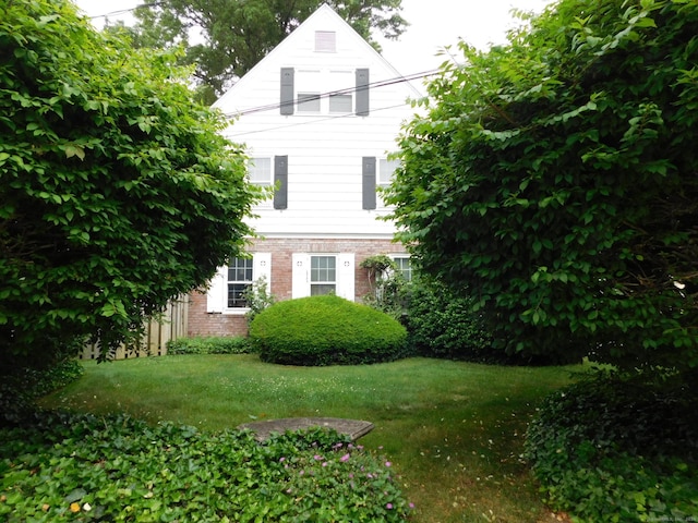 58 Edward St, East Haven, CT 06512 - view of front facade with brick siding and a front yard