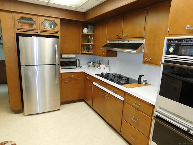 58 Edward St, East Haven, CT 06512 - kitchen with stainless steel appliances, open shelves, under cabinet range hood, light countertops, and brown cabinetry