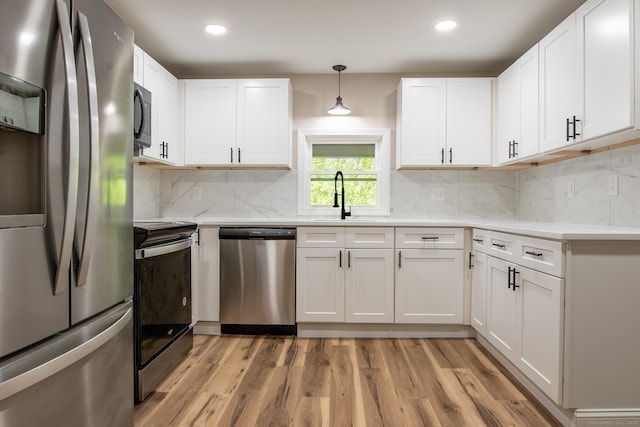 859 Ekonk Hill Rd, Voluntown, CT 06384 - kitchen featuring appliances with stainless steel finishes, light countertops, light wood-type flooring, white cabinetry, and recessed lighting