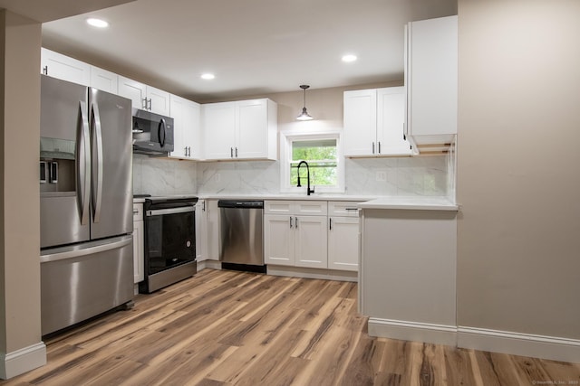 859 Ekonk Hill Rd, Voluntown, CT 06384 - kitchen featuring stainless steel appliances, light wood finished floors, light countertops, white cabinets, and recessed lighting