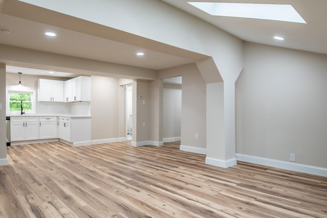 859 Ekonk Hill Rd, Voluntown, CT 06384 - unfurnished living room featuring a skylight, light wood-style flooring, and recessed lighting