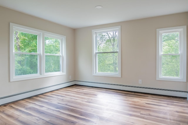 859 Ekonk Hill Rd, Voluntown, CT 06384 - empty room with a baseboard heating unit and light wood finished floors
