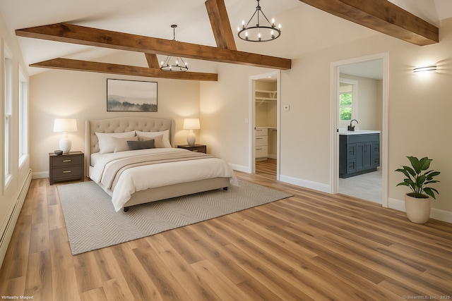 859 Ekonk Hill Rd, Voluntown, CT 06384 - bedroom featuring a chandelier, light wood-style flooring, a spacious closet, baseboard heating, and connected bathroom