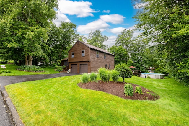 6 Old Sawmill Dr, Beacon Falls, CT 06403 - view of front facade with an outdoor pool, driveway, a front yard, an attached garage, and view of wooded area