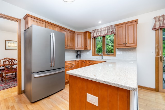 6 Old Sawmill Dr, Beacon Falls, CT 06403 - kitchen featuring freestanding refrigerator, light wood-style flooring, tasteful backsplash, a peninsula, and recessed lighting
