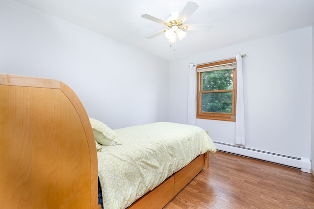 6 Old Sawmill Dr, Beacon Falls, CT 06403 - bedroom featuring a baseboard heating unit, light wood-style flooring, and ceiling fan