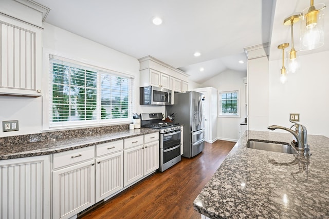 126 Sutton Dr E, Stamford, CT 06906 - kitchen featuring stainless steel appliances, dark wood-style flooring, dark stone counters, white cabinets, and vaulted ceiling