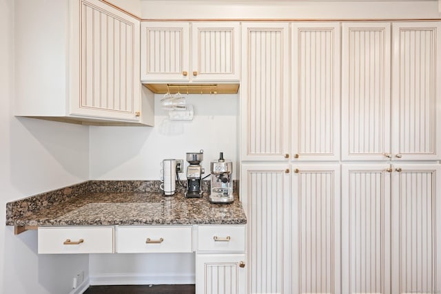126 Sutton Dr E, Stamford, CT 06906 - kitchen featuring dark stone counters and white cabinetry
