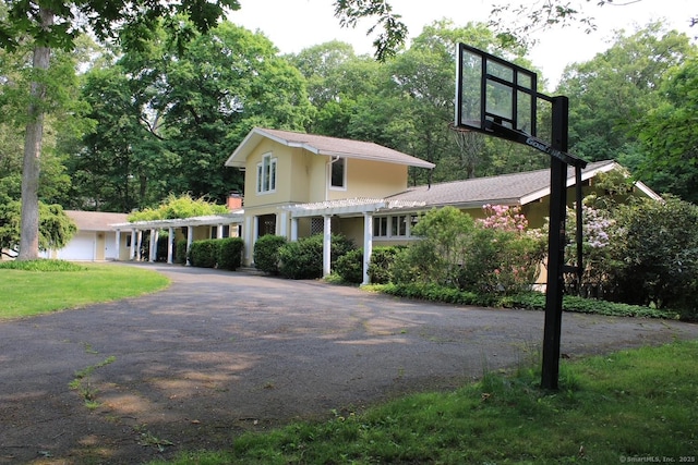 20 Shady Acres Rd, Darien, CT 06820 - view of front facade featuring a pergola, stucco siding, and driveway