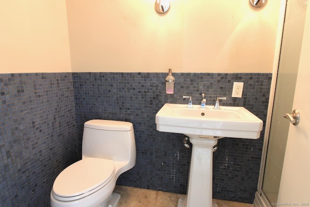 20 Shady Acres Rd, Darien, CT 06820 - bathroom featuring tile walls, wainscoting, tile patterned flooring, and a shower with door