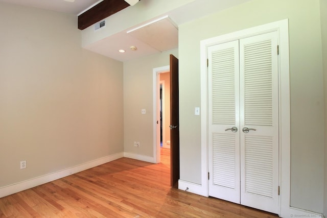 20 Shady Acres Rd, Darien, CT 06820 - unfurnished bedroom featuring light wood finished floors, a closet, and beamed ceiling