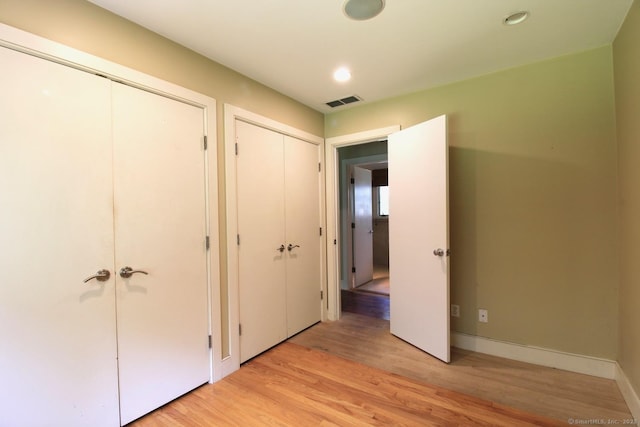 20 Shady Acres Rd, Darien, CT 06820 - unfurnished bedroom with light wood finished floors, two closets, and recessed lighting
