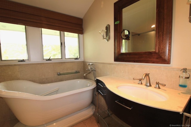 20 Shady Acres Rd, Darien, CT 06820 - bathroom featuring tile walls, vanity, a soaking tub, and a wainscoted wall