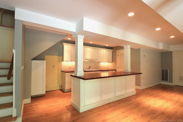20 Shady Acres Rd, Darien, CT 06820 - kitchen with light wood finished floors, recessed lighting, dark countertops, decorative columns, and white cabinets