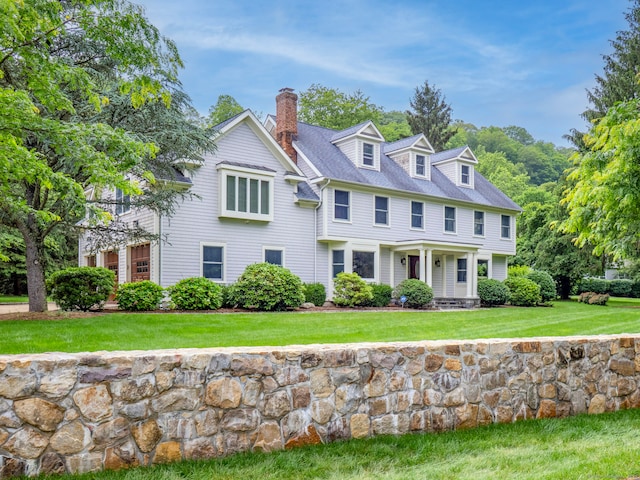 565 Danbury Rd, Wilton, CT 06897 - view of front of home featuring a chimney and a front yard