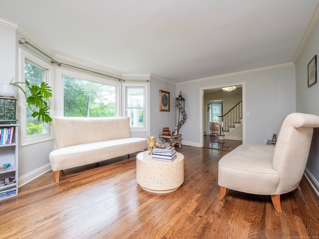 565 Danbury Rd, Wilton, CT 06897 - sitting room with wood finished floors, ornamental molding, and stairs