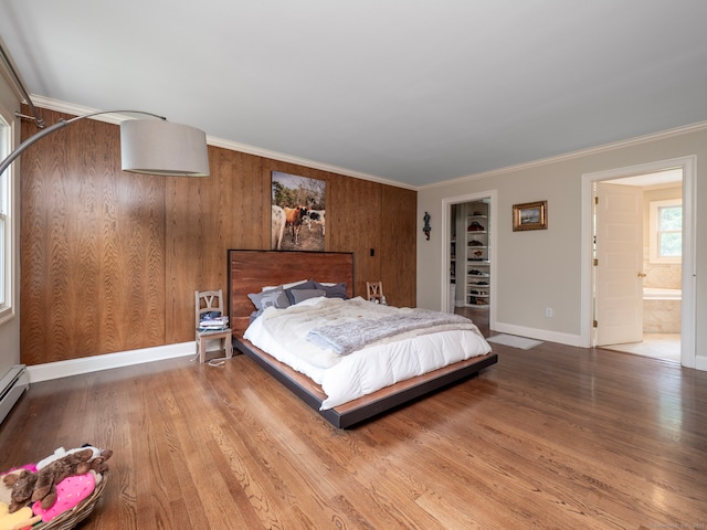 565 Danbury Rd, Wilton, CT 06897 - bedroom featuring wood finished floors, a walk in closet, crown molding, connected bathroom, and a closet