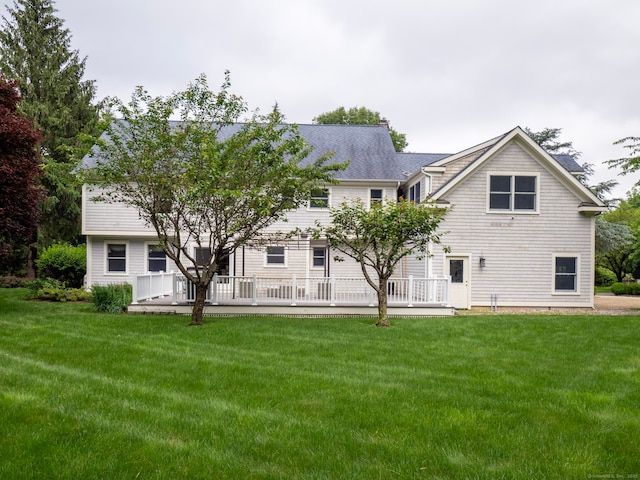 565 Danbury Rd, Wilton, CT 06897 - rear view of house with a wooden deck, a yard, and roof with shingles