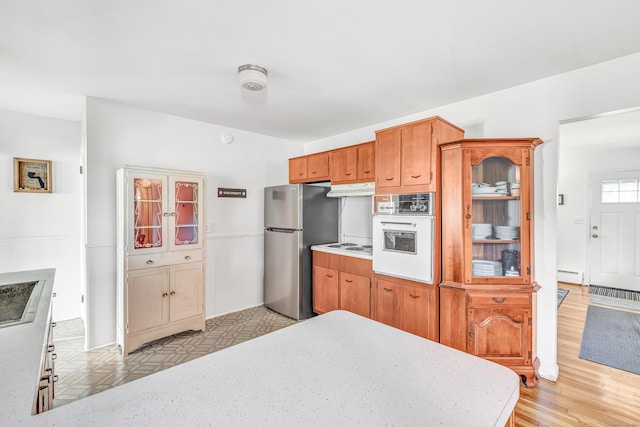 23 Laurel Wood Dr, Shelton, CT 06484 - kitchen featuring freestanding refrigerator, oven, under cabinet range hood, and light countertops