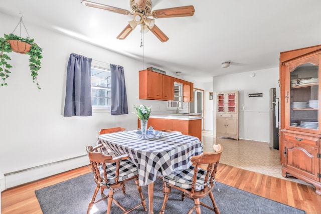 23 Laurel Wood Dr, Shelton, CT 06484 - dining space with a baseboard heating unit, a ceiling fan, and light wood finished floors