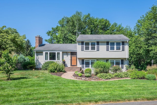 35 Twelve Acre Ln, Glastonbury, CT 06033 - split level home featuring a chimney and a front yard