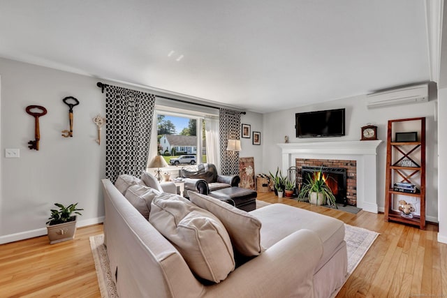 35 Twelve Acre Ln, Glastonbury, CT 06033 - living room with an AC wall unit, a fireplace, and light wood-style flooring
