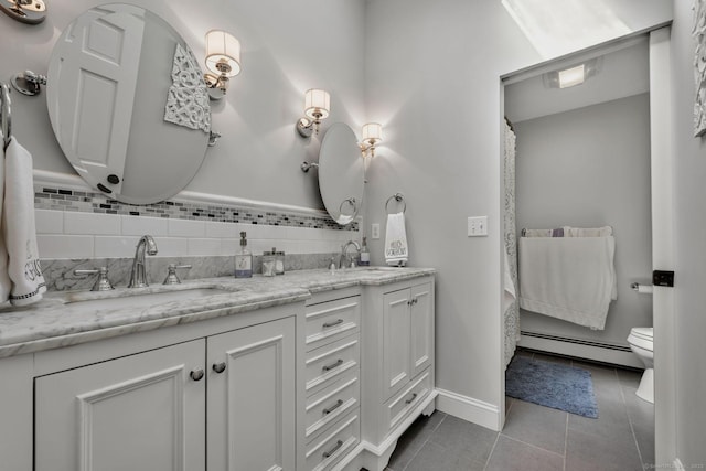 35 Twelve Acre Ln, Glastonbury, CT 06033 - bathroom with a baseboard radiator, double vanity, tile patterned floors, curtained shower, and decorative backsplash