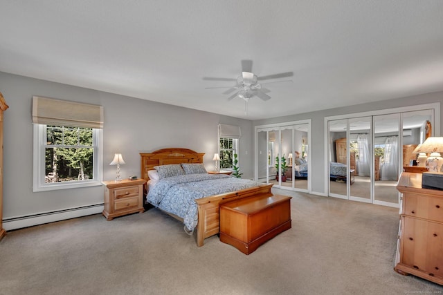35 Twelve Acre Ln, Glastonbury, CT 06033 - bedroom featuring baseboard heating, multiple windows, light carpet, and two closets