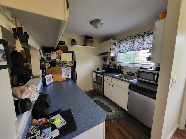 16 Seymour Rd Unit 9B, East Granby, CT 06026 - kitchen with stainless steel appliances, under cabinet range hood, dark countertops, dark wood-style flooring, and white cabinets