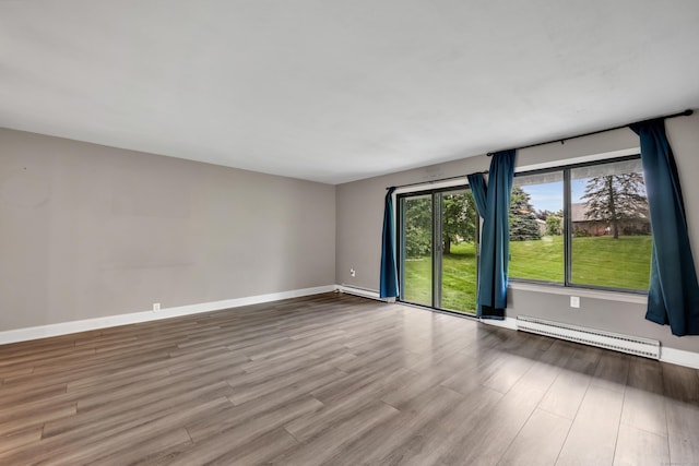 16 Pine Ct Unit 16, Cromwell, CT 06416 - spare room featuring a baseboard heating unit and wood finished floors