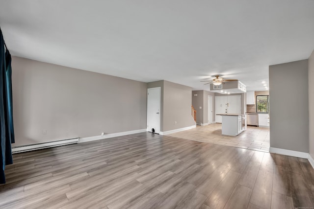 16 Pine Ct Unit 16, Cromwell, CT 06416 - unfurnished living room with a baseboard heating unit, light wood-style flooring, and a ceiling fan