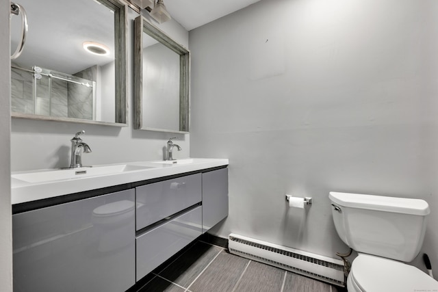 16 Pine Ct Unit 16, Cromwell, CT 06416 - bathroom with a baseboard radiator, double vanity, and a shower with door