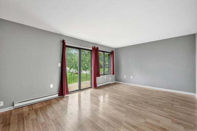 16 Pine Ct Unit 16, Cromwell, CT 06416 - empty room with a baseboard heating unit and wood finished floors