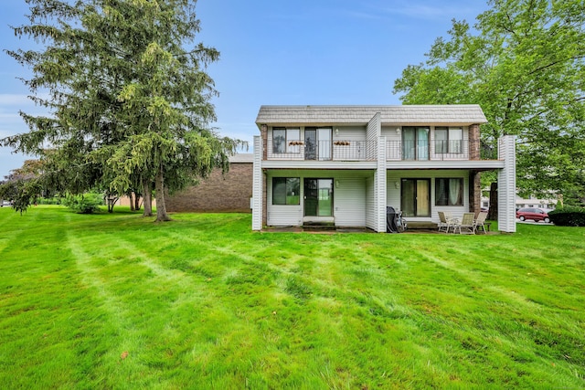 16 Pine Ct Unit 16, Cromwell, CT 06416 - rear view of house featuring a balcony and a lawn