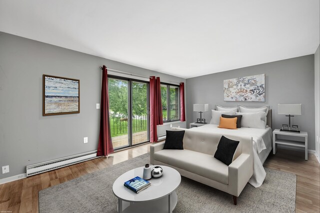 16 Pine Ct Unit 16, Cromwell, CT 06416 - bedroom featuring a baseboard heating unit, access to outside, and wood finished floors