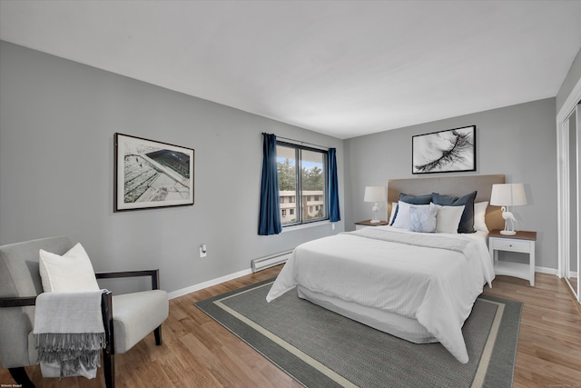 16 Pine Ct Unit 16, Cromwell, CT 06416 - bedroom with a baseboard heating unit and light wood finished floors