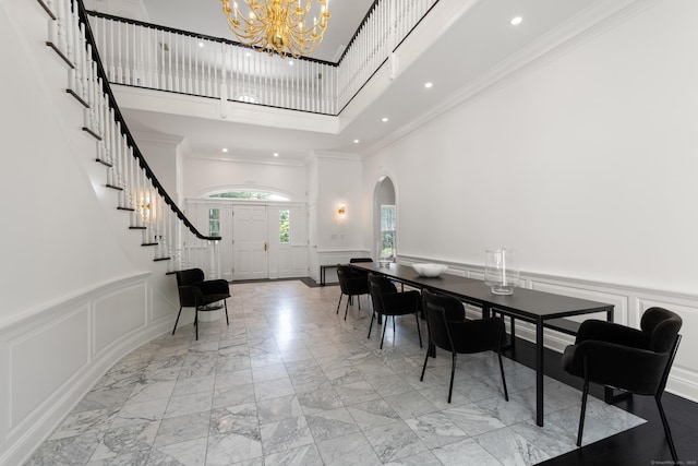34 Edgewood Dr, Greenwich, CT 06831 - dining space with a decorative wall, a towering ceiling, arched walkways, marble finish flooring, and a chandelier