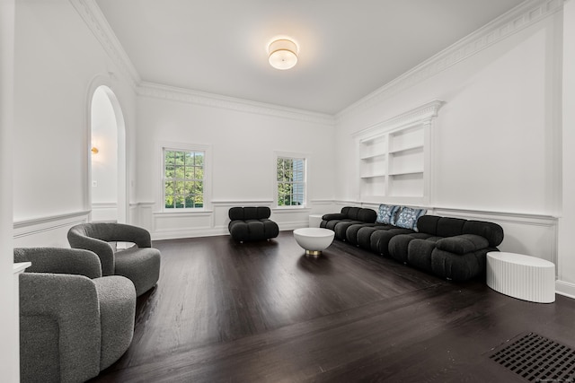 34 Edgewood Dr, Greenwich, CT 06831 - sitting room featuring wood finished floors, crown molding, a wainscoted wall, and arched walkways