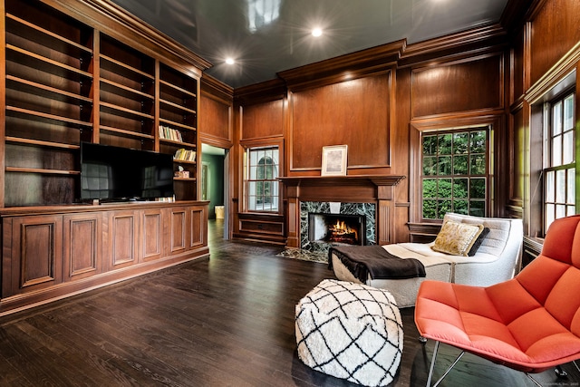 34 Edgewood Dr, Greenwich, CT 06831 - living area featuring built in features, plenty of natural light, a high end fireplace, dark wood-style flooring, and crown molding
