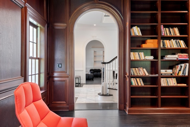34 Edgewood Dr, Greenwich, CT 06831 - sitting room featuring arched walkways, a decorative wall, crown molding, healthy amount of natural light, and wood finished floors
