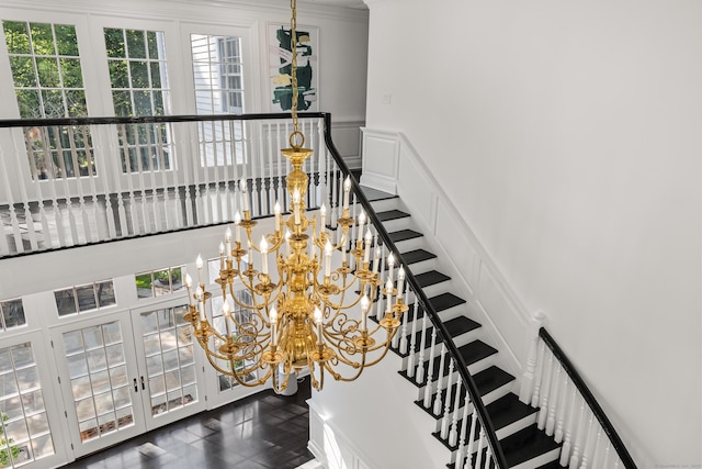 34 Edgewood Dr, Greenwich, CT 06831 - stairway featuring a chandelier, a decorative wall, a wainscoted wall, and ornamental molding