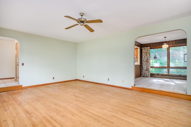 24 Warwick Rd, New Fairfield, CT 06812 - spare room with baseboard heating, arched walkways, wood finished floors, and ceiling fan
