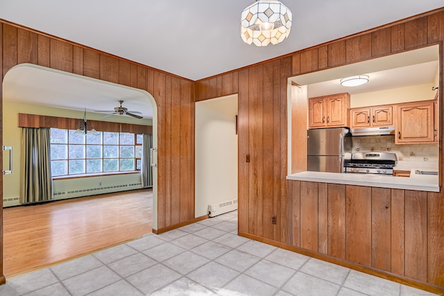 24 Warwick Rd, New Fairfield, CT 06812 - kitchen with appliances with stainless steel finishes, under cabinet range hood, wood walls, baseboard heating, and light countertops