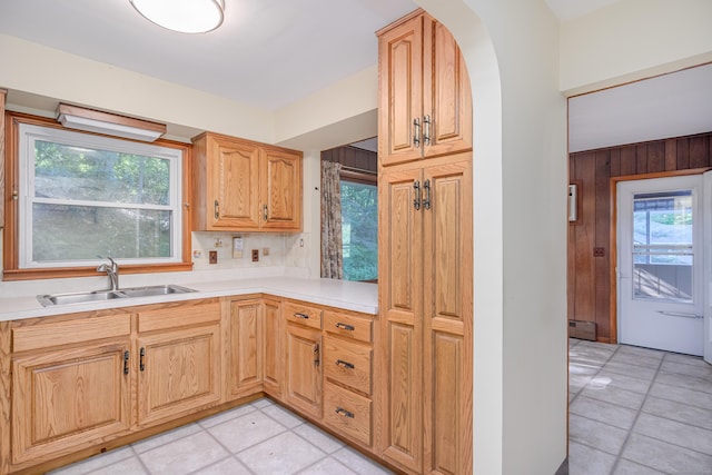 24 Warwick Rd, New Fairfield, CT 06812 - kitchen featuring arched walkways, light countertops, light tile patterned floors, and wooden walls